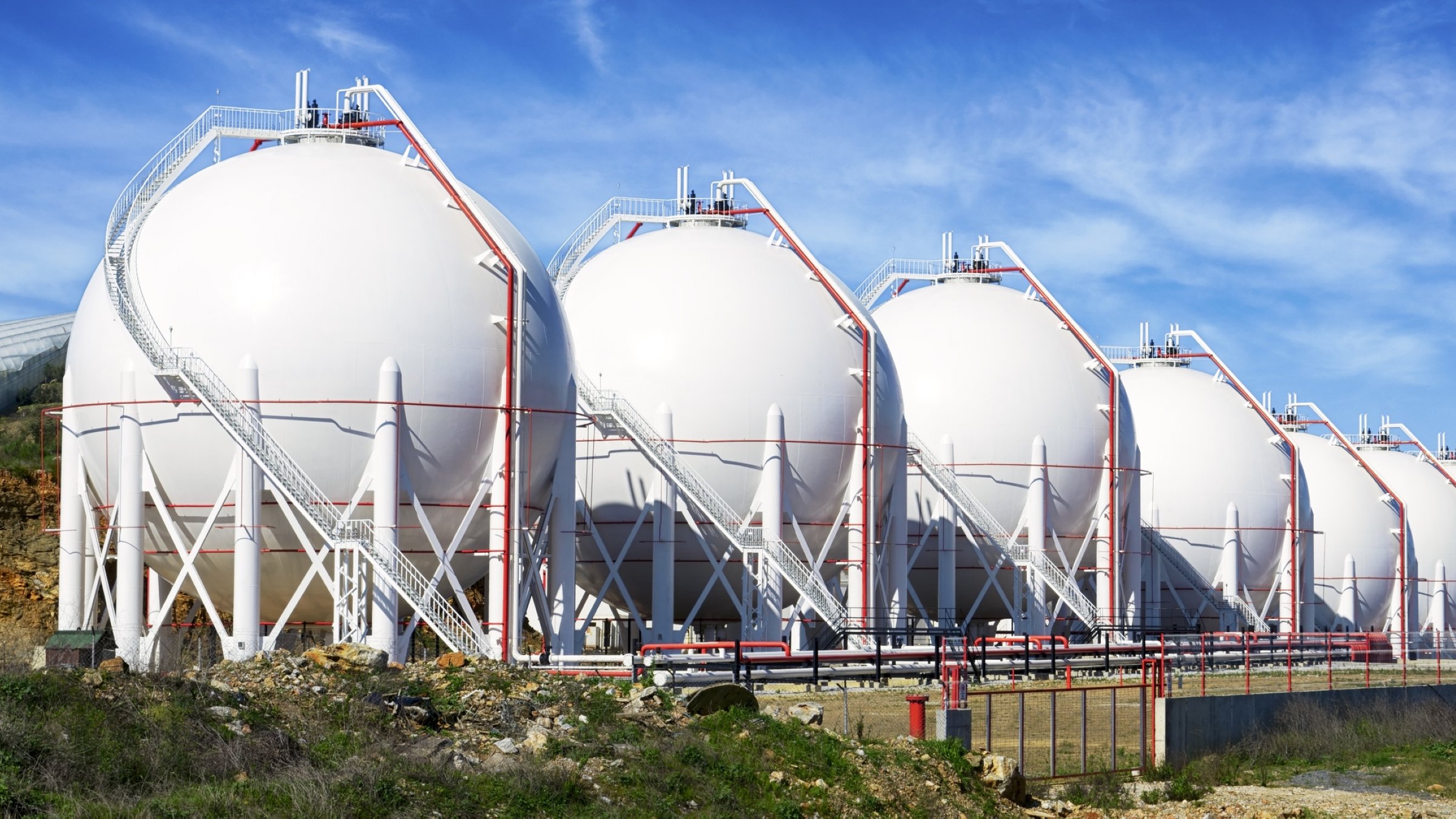 Liquefied natural gas (LNG) tanks are lined up in a row. (Getty Images Photo)